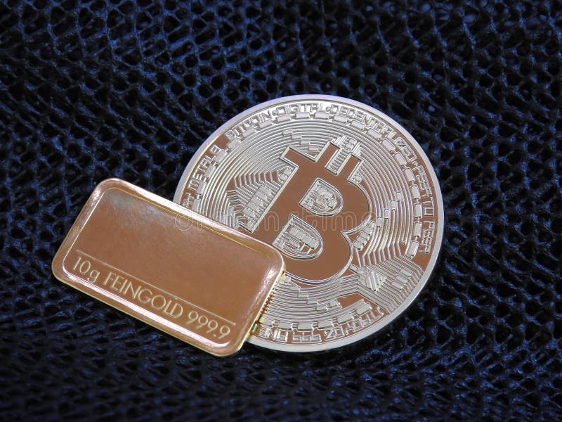 Golden Bitcoin and gold bar. stock photo