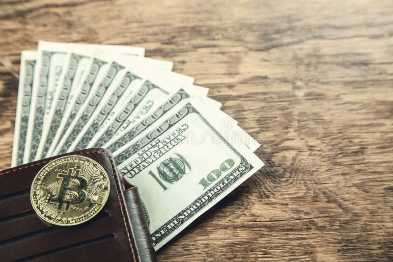 Golden Bitcoin with wallet and dollars on wooden background. stock photography Golden Bitcoin with wallet and dollars on wooden background. stock photography