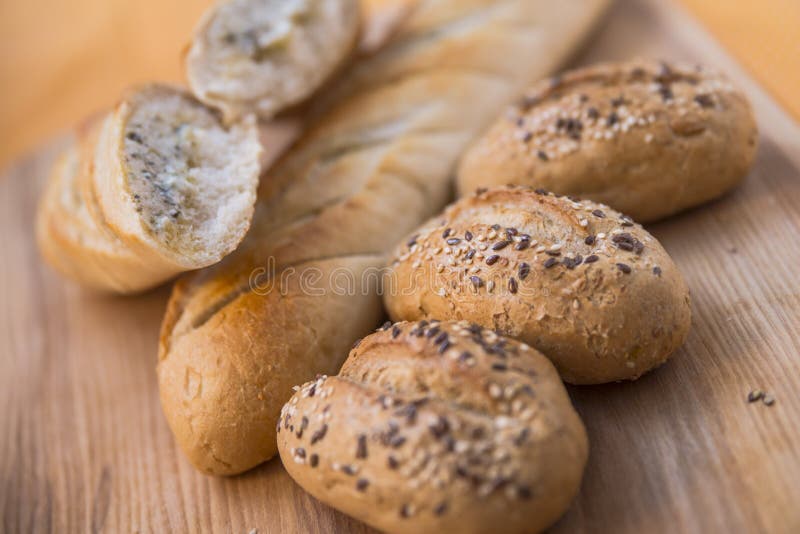 Golden brown loaf of french bread and rolls