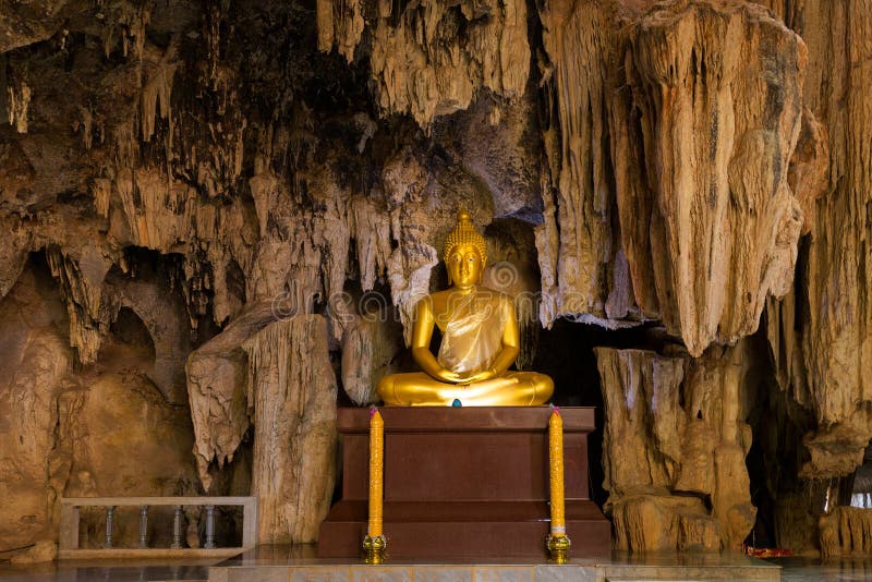 Golden Buddha statue in cave