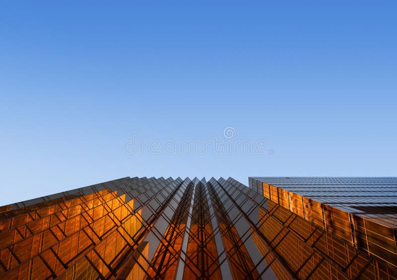 Golden building with blue sky. Windows glass of modern office sk