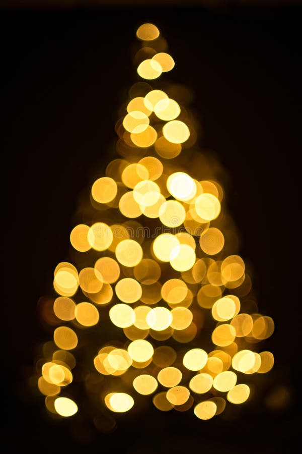 Golden Christmas Tree Bokeh in a Black Background Stock Photo Image