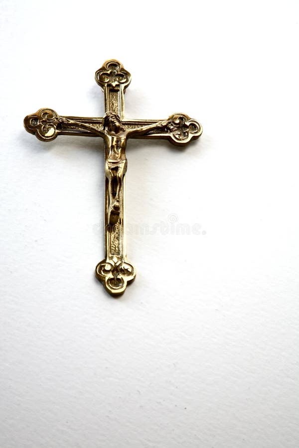 Golden cross with Christ on a white background