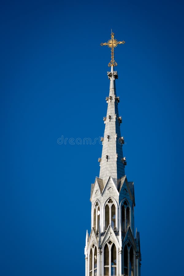 Golden Crucifix Atop Tall Church Steeple