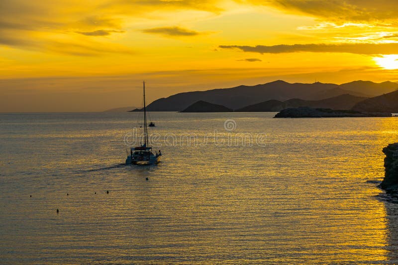 Golden sunrise over the mountains and the sea. Yacht and boat overlook the sea. Magnificent landscape stock photos Golden sunrise over the mountains and the sea. Yacht and boat overlook the sea. Magnificent landscape stock photos