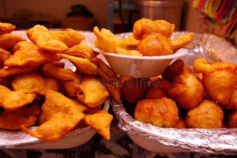 Golden and delicious doughs called bunuelos, ready to sell on a market