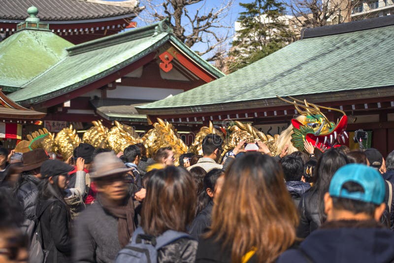 Golden dragon dancing through the crowd in the Sensoji temple of Asakusa.