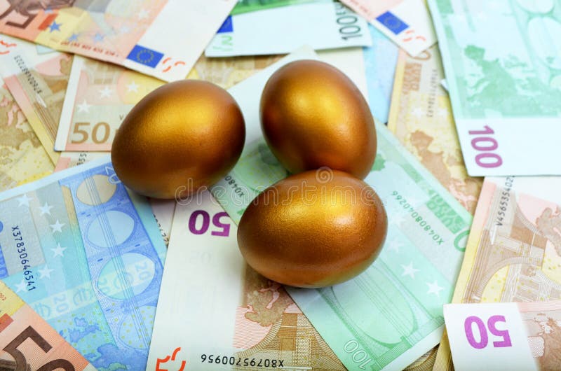 Golden Eggs sitting on money