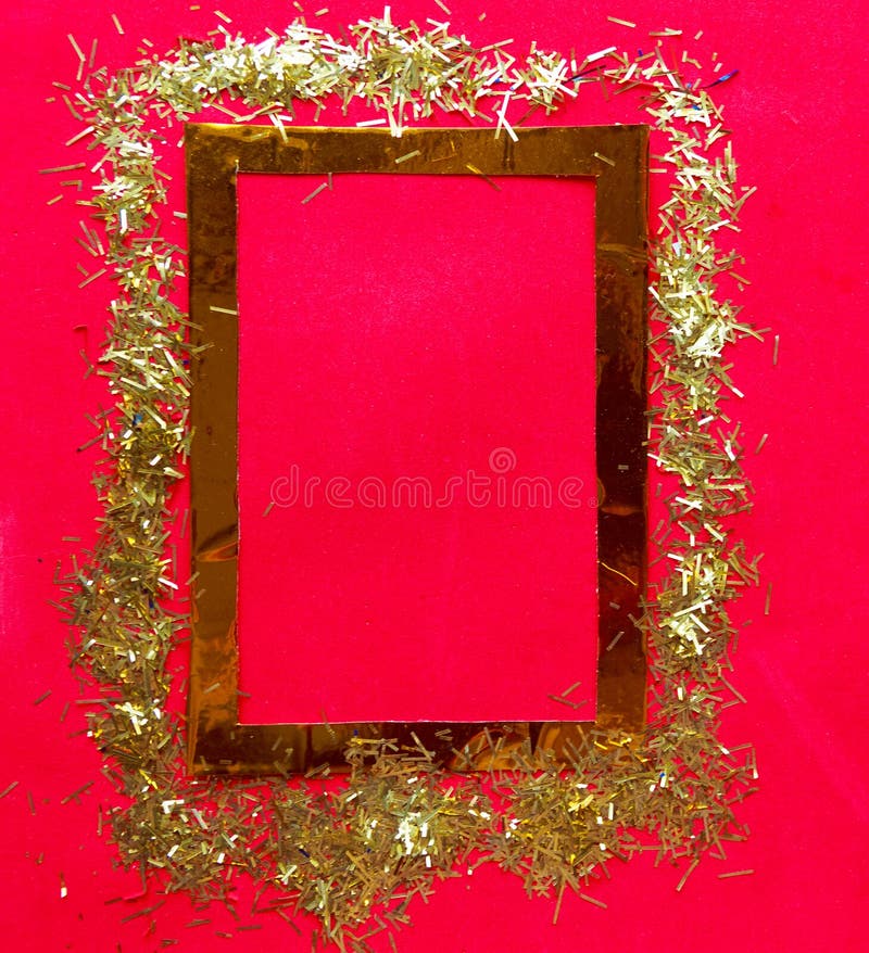 Golden frame with tinsel on bright red background. Copy space for the text. royalty free stock image Golden frame with tinsel on bright red background. Copy space for the text. royalty free stock image