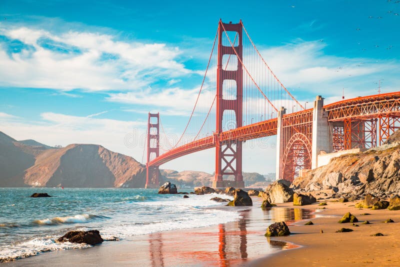 Classic view of famous Golden Gate Bridge in beautiful golden evening light on a sunny day with blue sky and clouds in summer, San Francisco, California, USA. Classic view of famous Golden Gate Bridge in beautiful golden evening light on a sunny day with blue sky and clouds in summer, San Francisco, California, USA