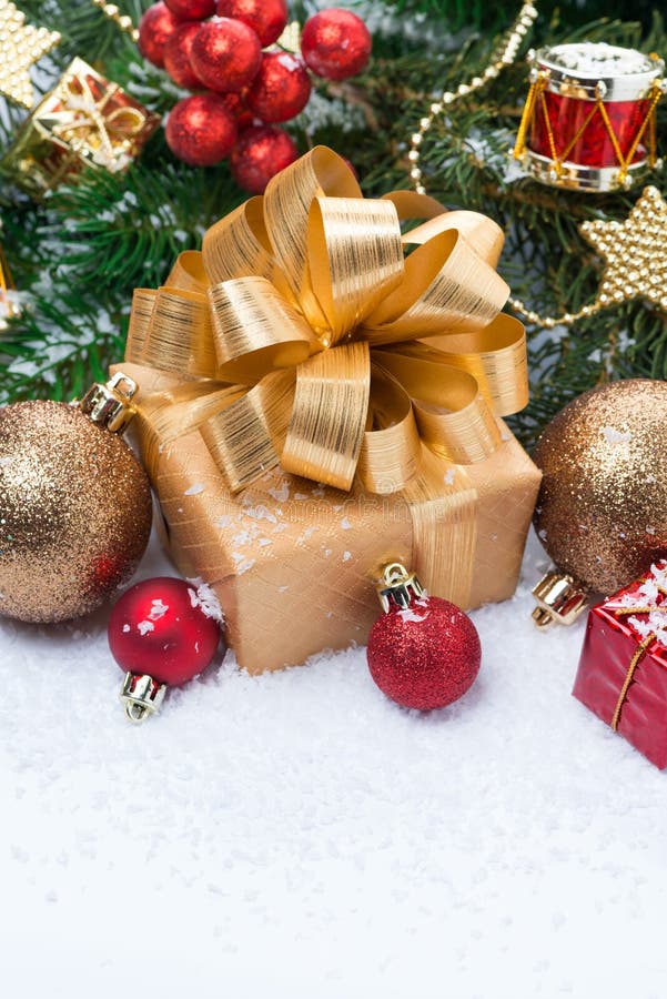 Golden Gift Box and Christmas Tree Decorations, Vertical Stock Photo