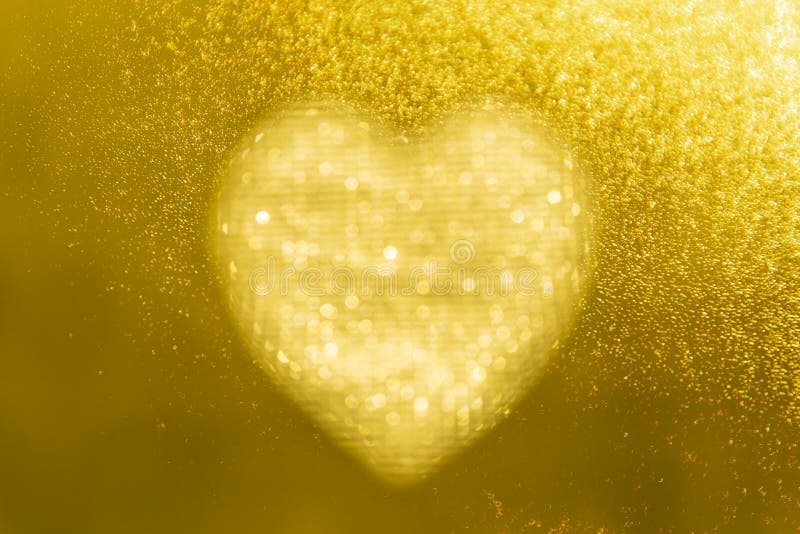 Golden heart bokeh frame on a gold background with space for your valentine wording concept stock images Golden heart bokeh frame on a gold background with space for your valentine wording concept stock images