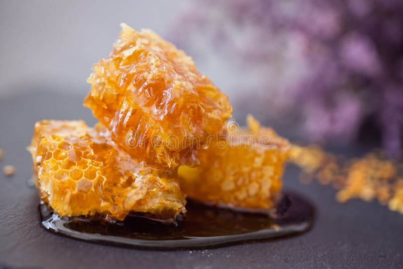 Golden honeycomb in the honey on the table royalty free stock photos
