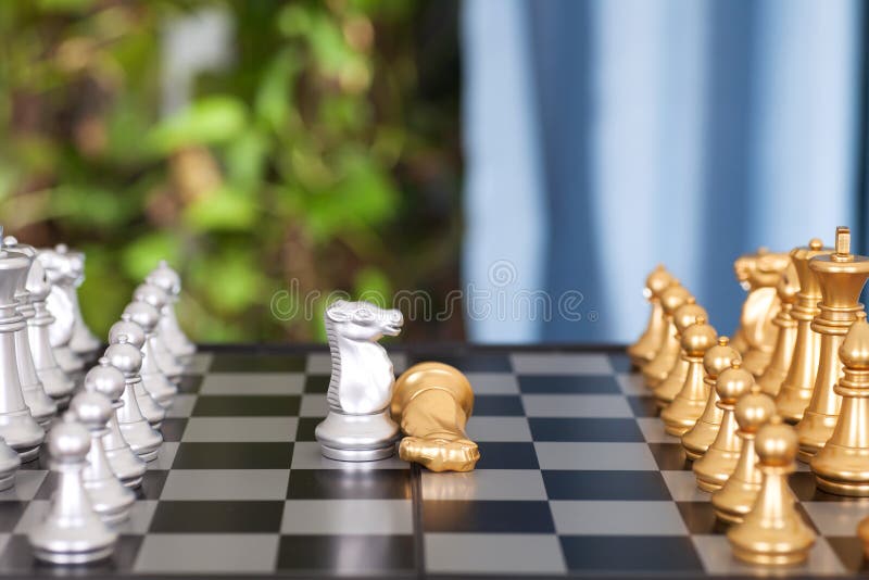 The Golden Horse Chess Piece on the Chess Board Surrenders Stock Photo