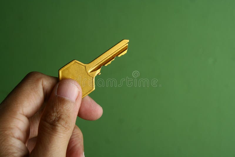 Golden key held in hand royalty free stock images