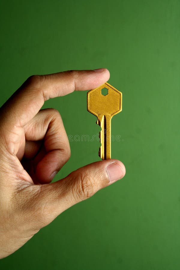 Golden key held in hand royalty free stock photo