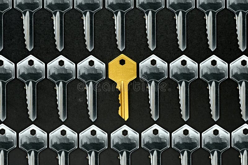 Golden key among ordinary keys stock image