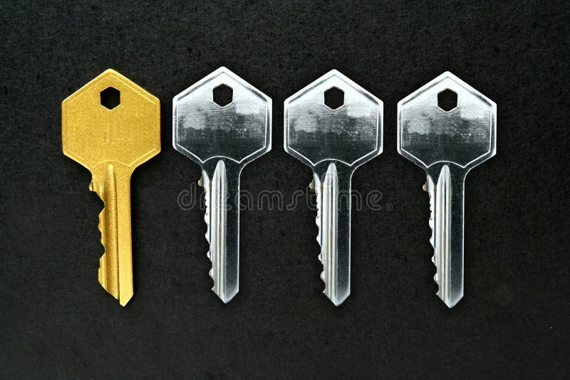 Golden key among ordinary keys stock photography