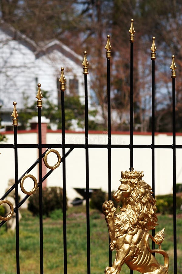 A golden lion on a cast iron gate