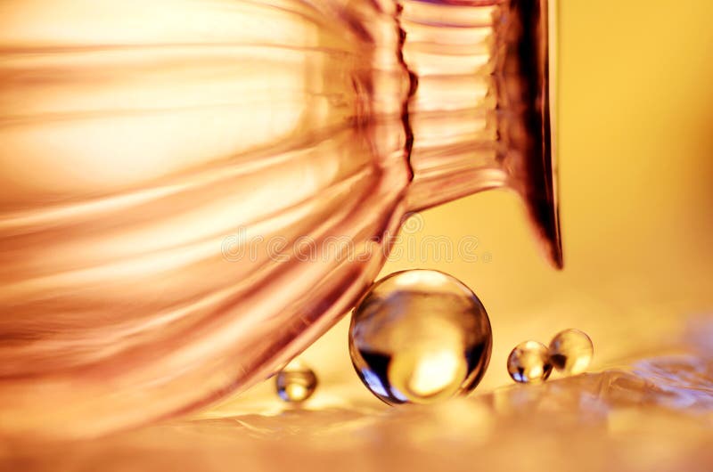 Golden marbles and a glass