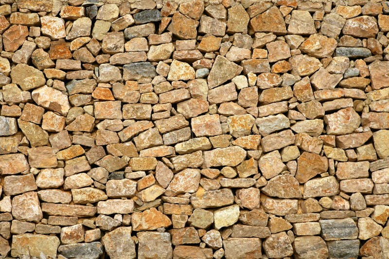 Golden masonry stone wall from old building stock photos
