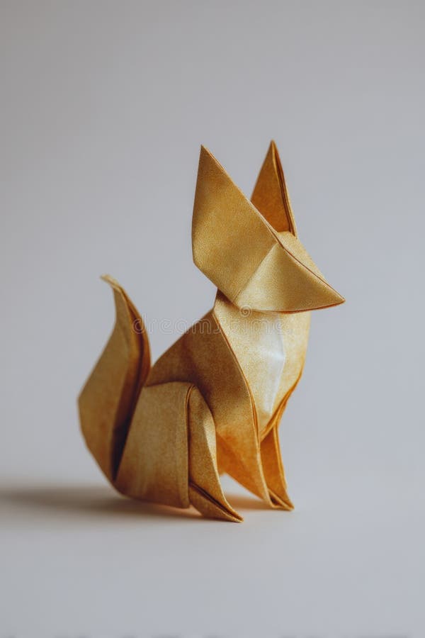 Golden Origami Fox on White Background with Realistic Paper Texture royalty free stock photo