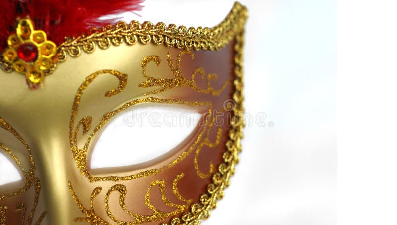 A gold and red masquerade party mask over white background. A gold and red masquerade party mask over white background