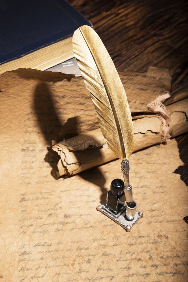 Golden pen and ancient manuscripts