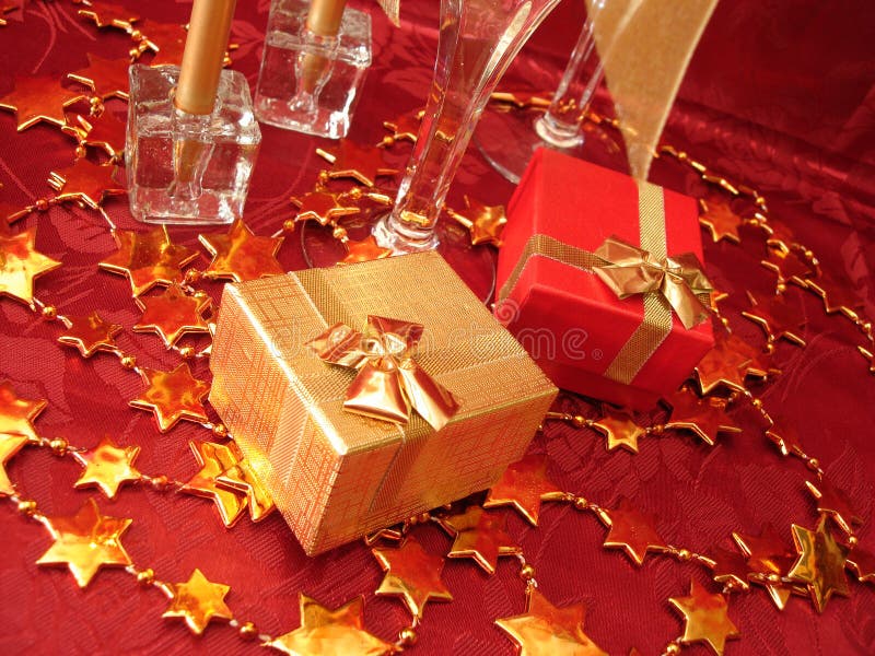 Golden and red gift boxes, stars on beautiful background with ch