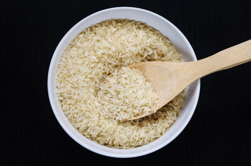 Golden Rice in a Bowl with Spoon on Dark Table Stock Photo Image of