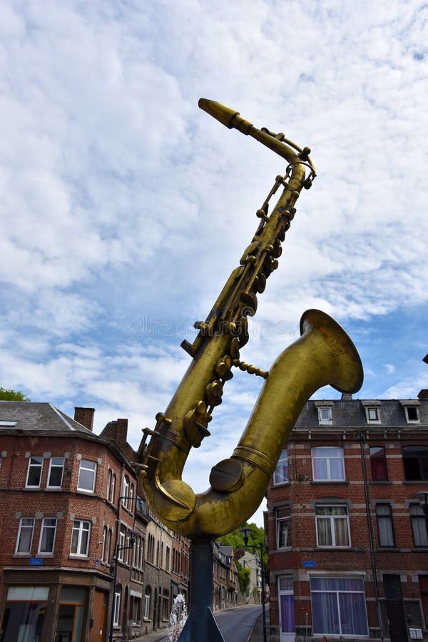 The golden saxophone sculpture in memory of Adolphe Sax stock image The golden saxophone sculpture in memory of Adolphe Sax stock image