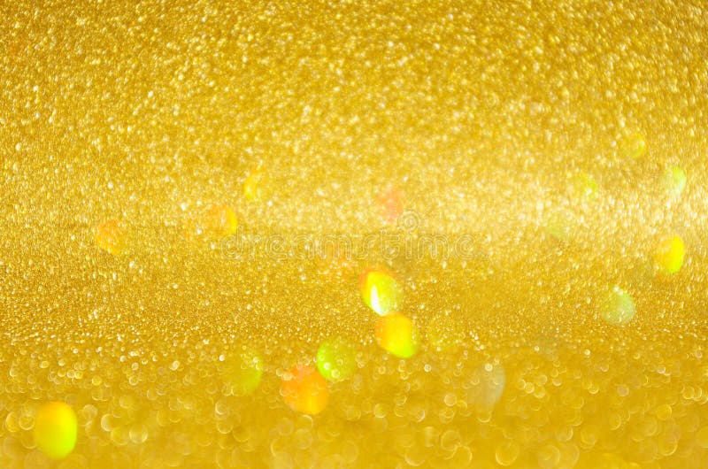 Golden shining glowing bokeh abstract texture with flying holographic glitter for Christmas and festive design. royalty free stock image Golden shining glowing bokeh abstract texture with flying holographic glitter for Christmas and festive design. royalty free stock image