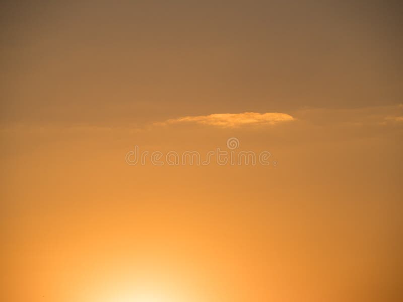 Golden sky with one lonely cloud royalty free stock photography