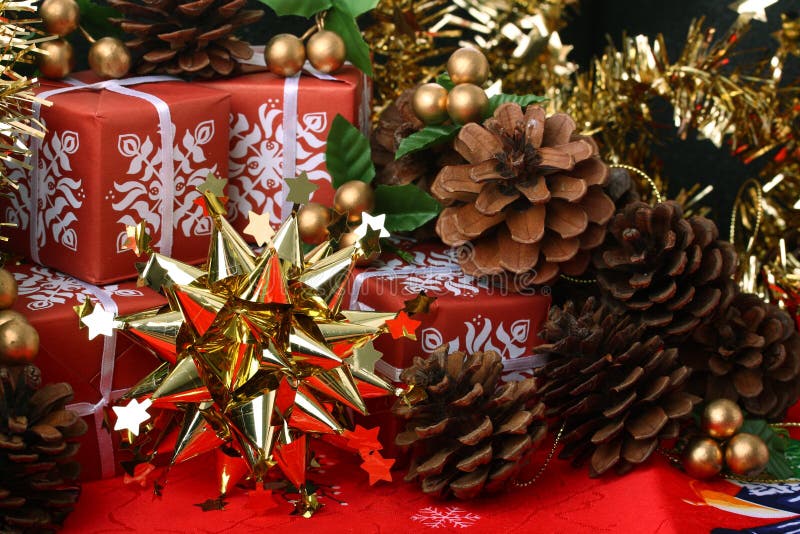 Golden star with red gift boxes and fir cones