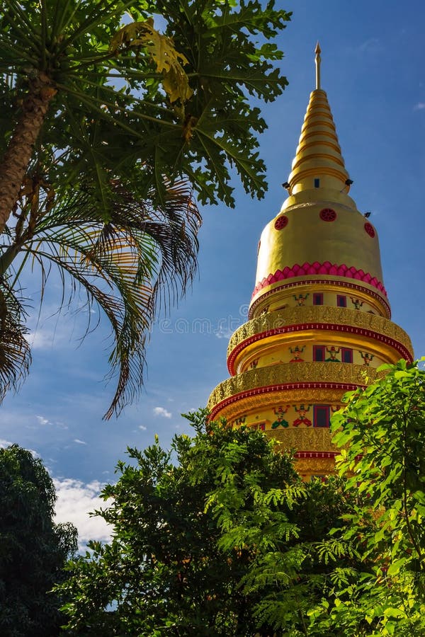 The golden stupa of Wat Chaiyamangkalaram between the trees, Thai buddhist temple in Pulau Tiku area, Georgetown, Penang, Malaysia royalty free stock photos The golden stupa of Wat Chaiyamangkalaram between the trees, Thai buddhist temple in Pulau Tiku area, Georgetown, Penang, Malaysia royalty free stock photos