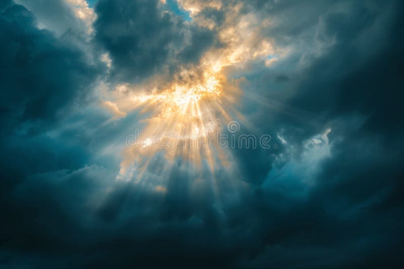 Golden sun rays piercing through stormy clouds, representing new beginnings, light, and inspiration royalty free stock images