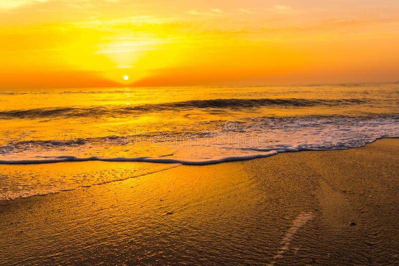 Golden sunrise sunset over the sea ocean waves