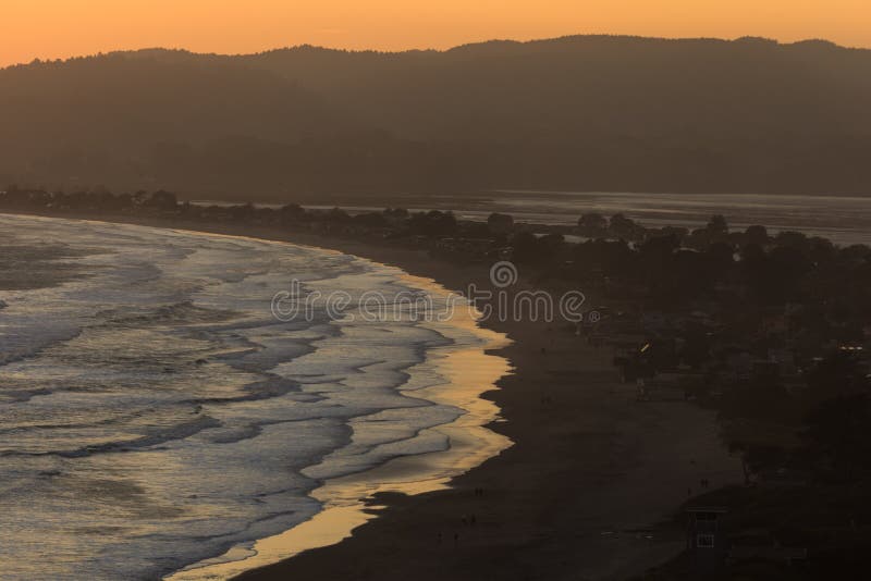 Golden sunset reflects on water s edge at Stinson Beach