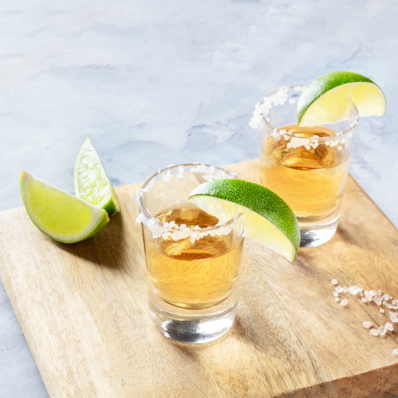 Golden Tequila Shots with Lime Slices and Salt, with Copy Space Stock