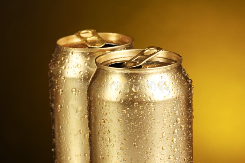 Two golden beer cans stock image. Image of metal, liquid 6508425