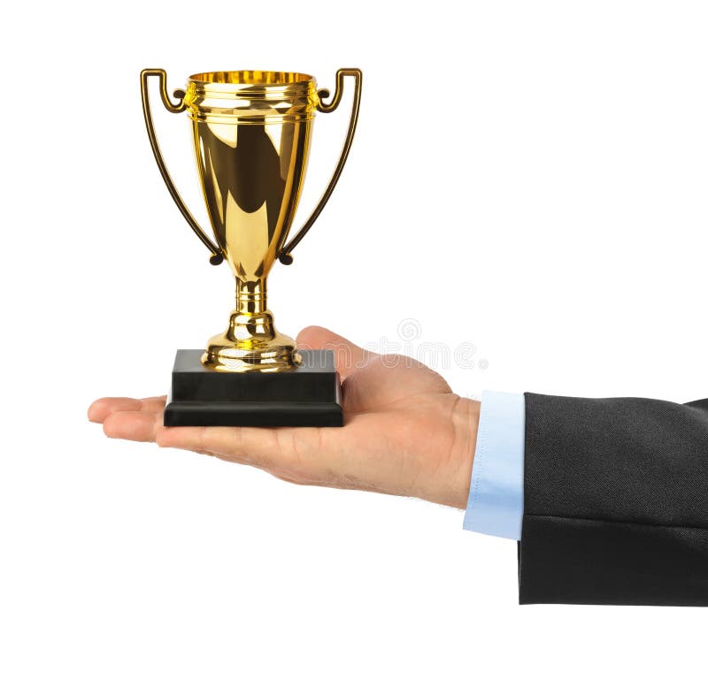 Golden trophy cup in hand royalty free stock image