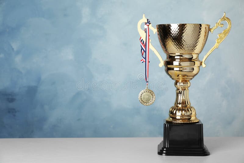 Golden Trophy Cup and Medal on Table Against Background. Space for Text  Stock Photo - Image of championship, copy: 159634596