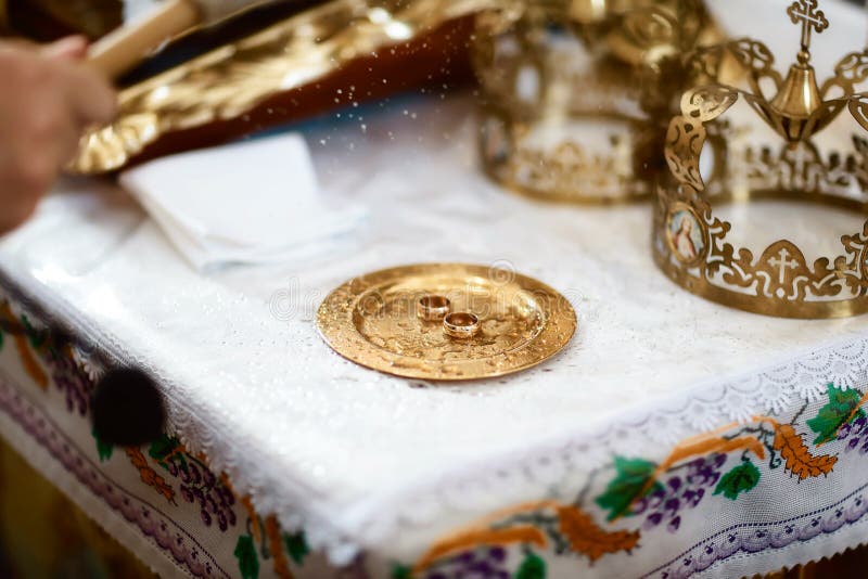Golden wedding rings near the altar in the church for the wedding couple of the traditional religious wedding ceremony royalty free stock image Golden wedding rings near the altar in the church for the wedding couple of the traditional religious wedding ceremony royalty free stock image