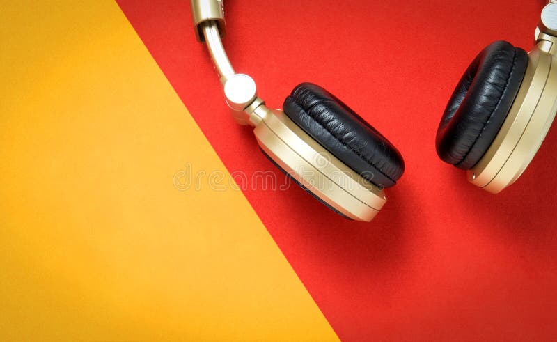 Golden Wireless Audio headphone on red and gold background