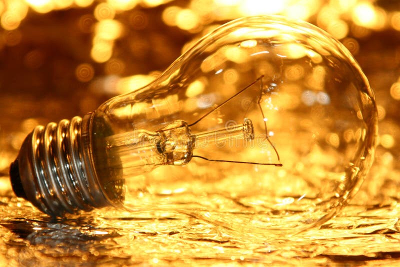 Goldene Glühlampe stockbilder Goldene Glühlampe stockbilder
