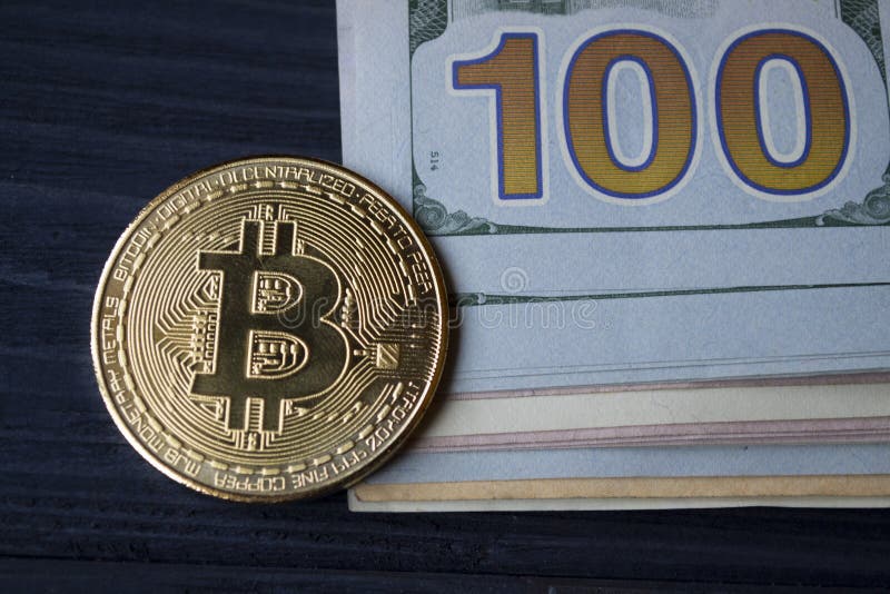 Goldenes bitcoin auf Rechnungen eines Hundertdollars