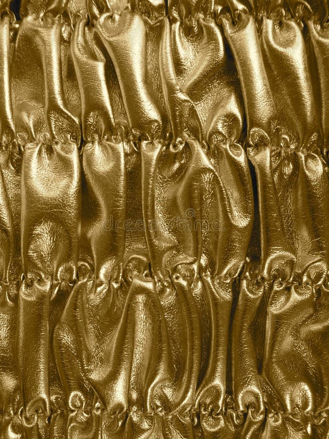 Golden shiny shirred background. Metallic texture. Golden shiny shirred background. Metallic texture