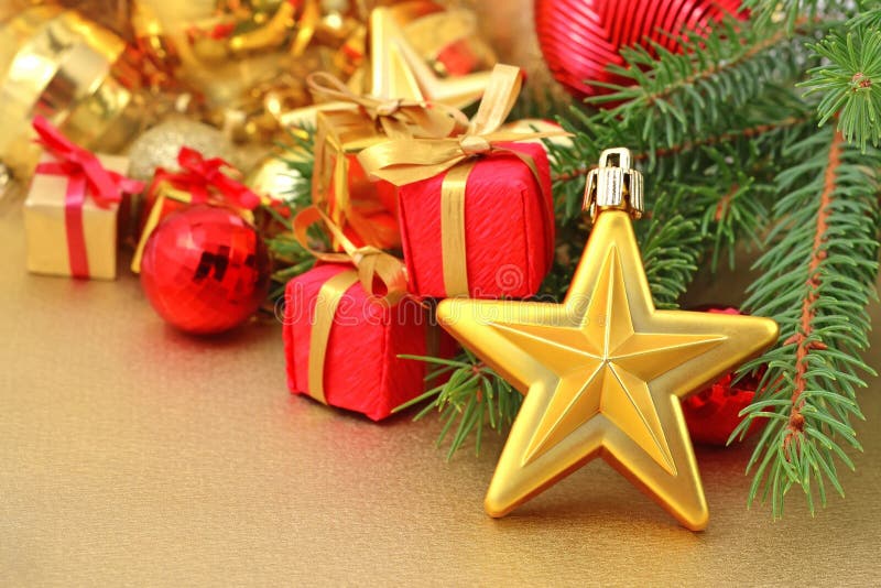 Gold star and Christmas decorations on a spruce branch. Gold star and Christmas decorations on a spruce branch