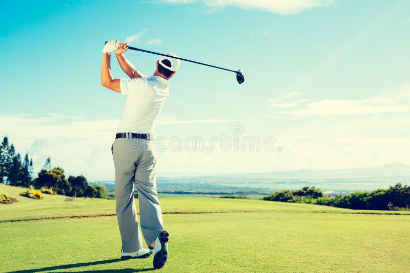 Golfer Hitting Golf Shot with Club on Beautiful Golf Course on Vacation