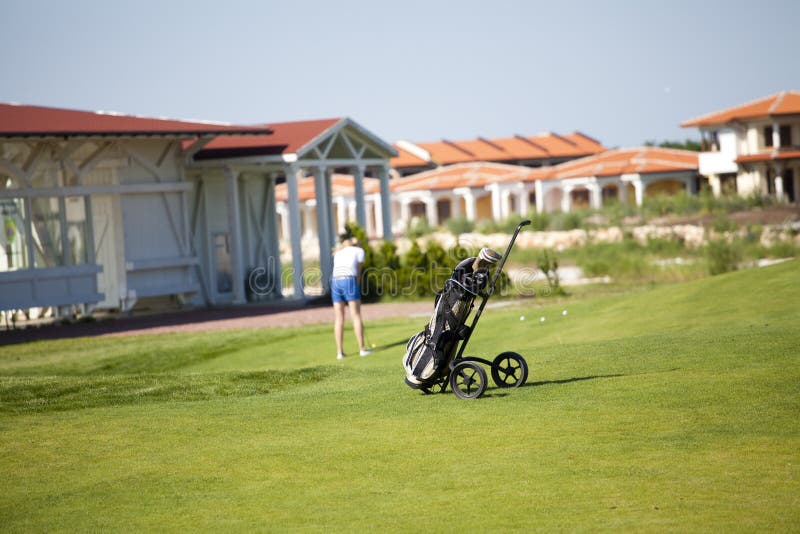 Golf bag with woman playing back